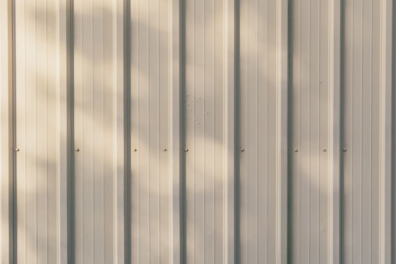 Worker attaching siding panels